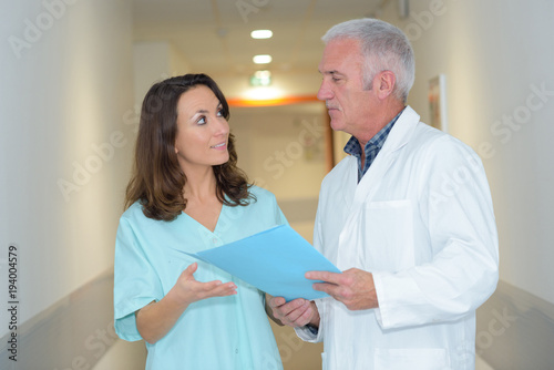 Fotografie, Obraz doctor and medical assistant having a conversation