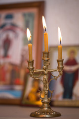 Wall Mural - candle against the background of orthodox icons