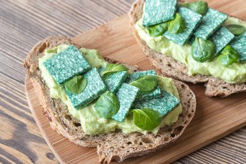 Sticker - Slices of toasted bread with avocado paste and basil cheese