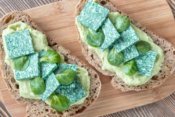 Sticker - Slices of toasted bread with avocado paste and basil cheese