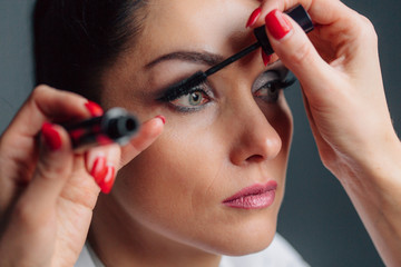 Process of making makeup. Make-up artist working with brush