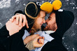 © dmytro_khlystun - Young couple in the penguin costumes are have fun on snow. Happy Loving Couple