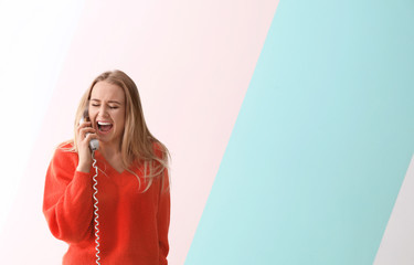 Wall Mural - Beautiful woman talking on phone against color background