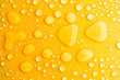 Leinwandbild Motiv water drops yellow background