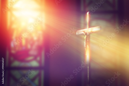 Fotomural crucifix, jesus on the cross in church with ray of light from stained glass