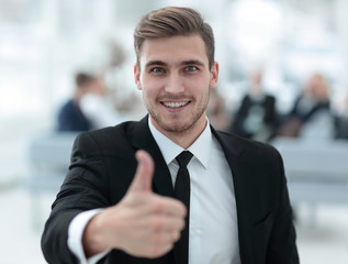 Poster - portrait of happy businessman showing thumb up.