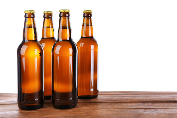 Canvas Print - Glass bottles of beer on table against white background