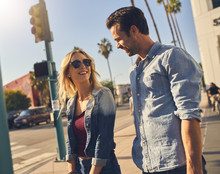 Happy Attractive Couple Waiting To Cross Street At Crosswalk In Los Angeles California