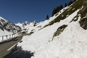 A snow slide blocks a road in the Alps of Switzerland