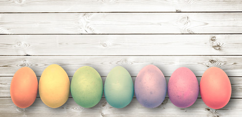 Wall Mural - Pastel colored eggs on  white wooden planks, panoramic easter background