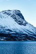 Snow covered mountain and the sea in a fjord near Narvik, Norway, Scandinavia