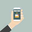 © chatchaisurakram - Hand holding smartphone and touching screen with text messaging.Smartphone with new message on screen.Chat,SMS,Instant messaging.Mobile messenger sign.Web banners.Smartphone message icon.