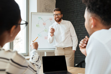 Sticker - Handsome young business man showing project on desk