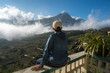 © Hanoi Photography - Male tourist sit on balcony seeing mountain landscape with low white clouds under brilliant sky. Ideas for travel and feeling.