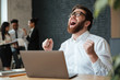© Drobot Dean - Screaming young caucasian businessman make winner gesture.