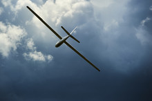A Glider Flying Into Storm. The Glider Is A Plane That Has No Engine
