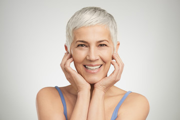 Portrait of beautiful senior woman in front of white background.