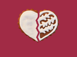 Wall Mural - Broken gingerbread heart isolated on red background