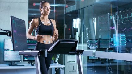 Wall Mural - beautiful woman athlete runs on a treadmill with electrodes attached to her body, female physician u