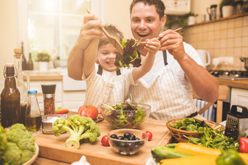 Wall Mural - Father is cooking with his son