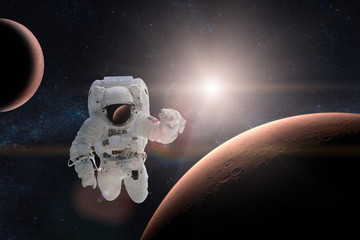 Wall Mural - astronaut in outer space on background of the mars. elements of this image furnished by nasa.