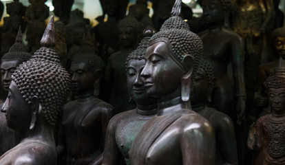 Wall Mural - Big Buddha statues in the local Thai market. Antique Buddha statues close-up 