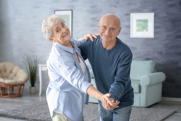 Poster - Cute elderly couple dancing at home