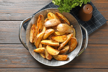 Sticker - Dish with tasty potato wedges on table