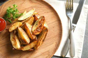 Sticker - Plate with tasty potato wedges and tomato sauce on table