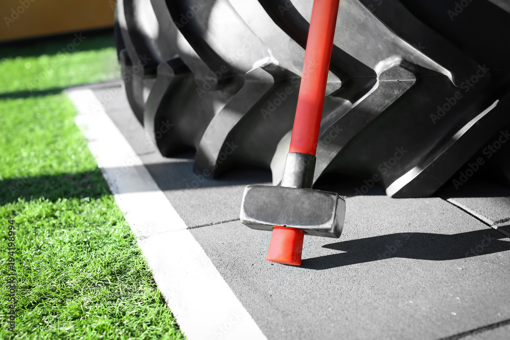 Heavy tire and hammer for training in gym