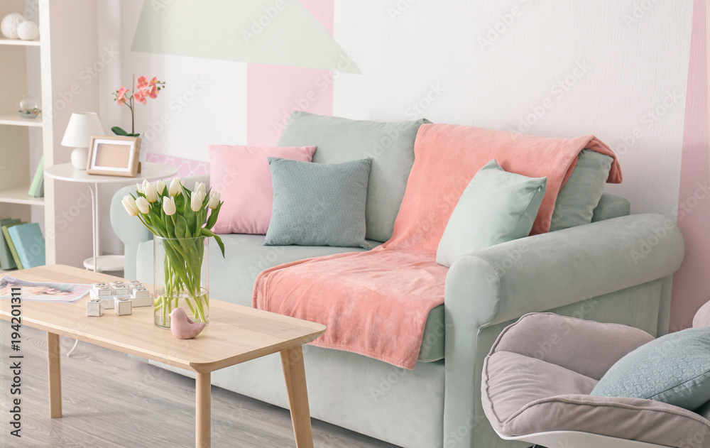 Elegant living room interior with table and comfortable sofa