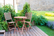 Empty Wood Table And Chairs On The Terrace At Summer Day