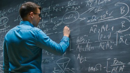 Wall Mural - Mathematician Approaches Big Blackboard and Finishes  writing Mathematical Formula.