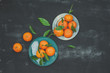 Tangerines on black table, top view
