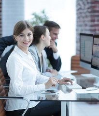 Poster - young employee sitting at a Desk