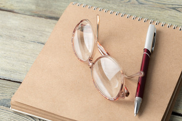 Wall Mural - notepad and eyeglasses on the table