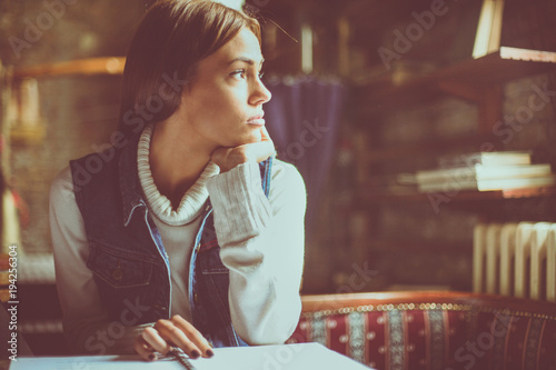 Fotografie, Obraz Student girl at home tired of learning and looking away.