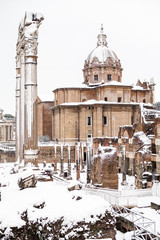 A lovely day of snow in Rome, Italy, 26th February 2018: a beautiful view of snowy Roman Forums and Church of the Saints Luca and Martina under the snow