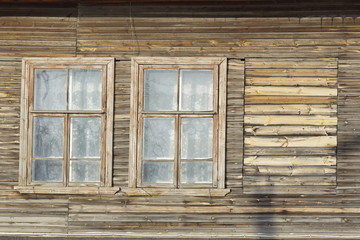 the windows of an old wooden dilapidated house. social problem.