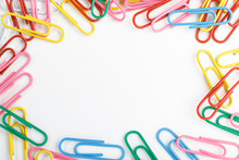 A Lot Of Colorful Paper Clips On White Background.