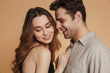 Canvas Print - Happy man looking at his lovely woman while standing isolated