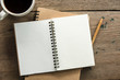 © Golden House Images - Top view of blank notebook with white coffee and natural light on wooden table.