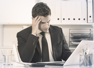 Frustrated businessman at office desk