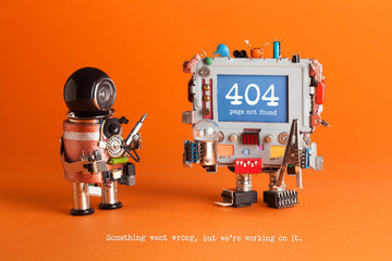 404 error page not found. Serviceman robot with screw driver, robotic computer warning message on blue screen. Orange background. Text Something went wrong but we are working on it