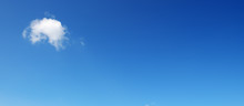 Panoramic Photo With Small Cloud On Bright Blue Sky Background.