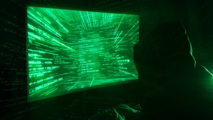 Poster - a man hacker in a hood in a dark room works with the program code