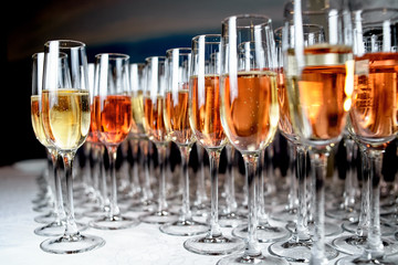 Lot of glasses with champagne and wine during on the party table. Party and holiday celebration concept