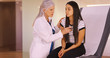 © Mark Adams - A young girl gets an annual check up. An elderly medical professional gives a girl her check-up