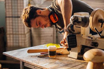 Wall Mural - Wood boring drill in hand drilling hole in wooden bar