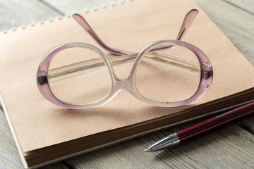 Wall Mural - notepad and eyeglasses on the table